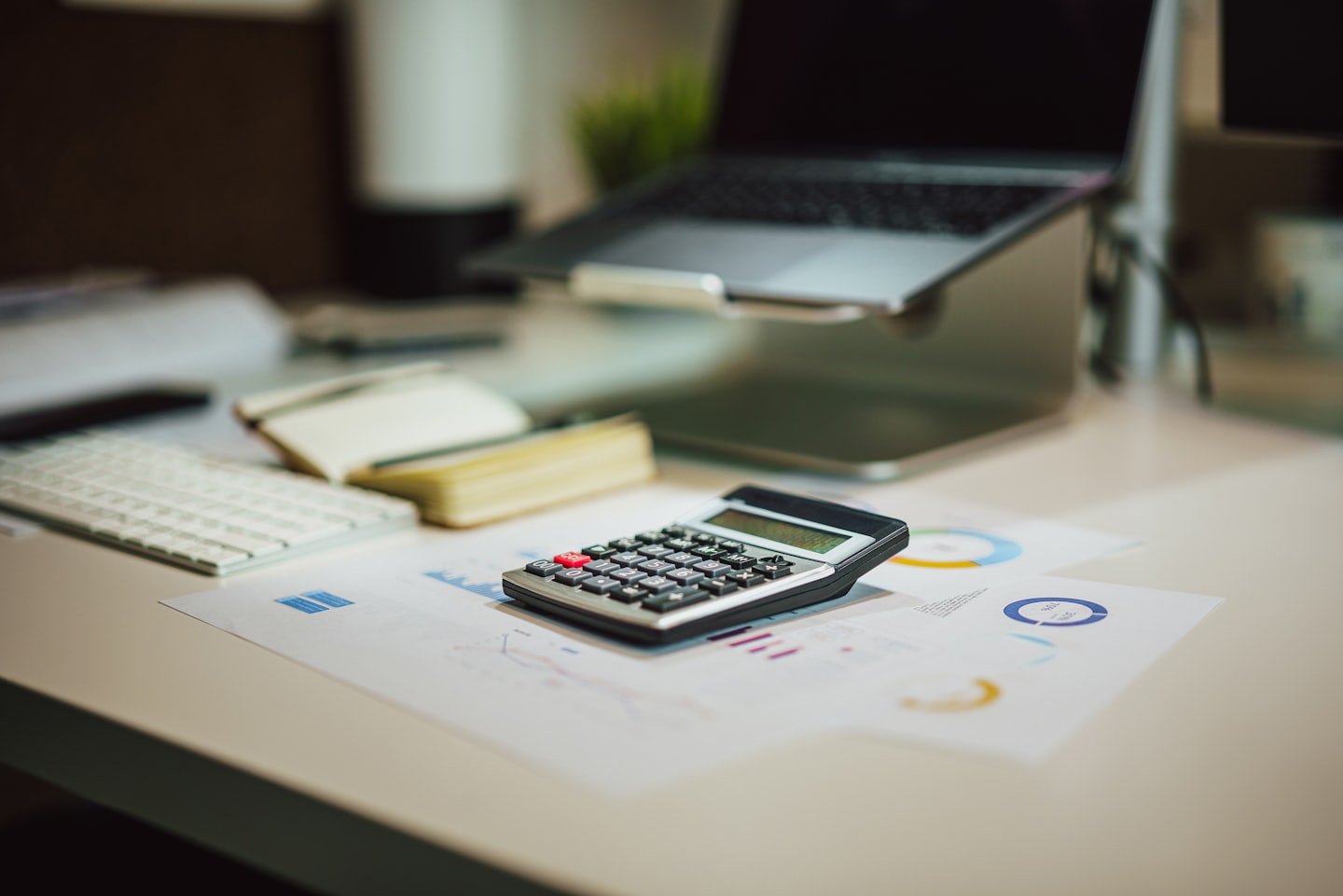 Calculator on financial documents at an office desk.